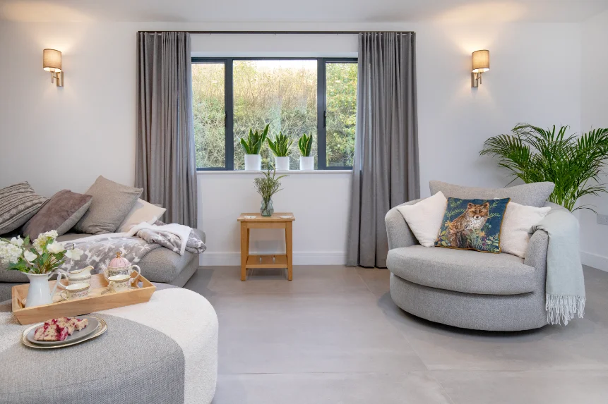 Modern living room in pale grey decor with circular style armchair