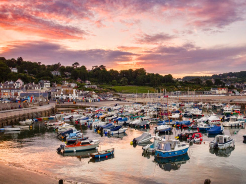 Sunset over the boats in the harbour at Lyme Regis